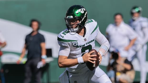 New York Jets quarterback Zach Wilson (2) rolls out during the second half against the New England Patriots at MetLife Stadium.